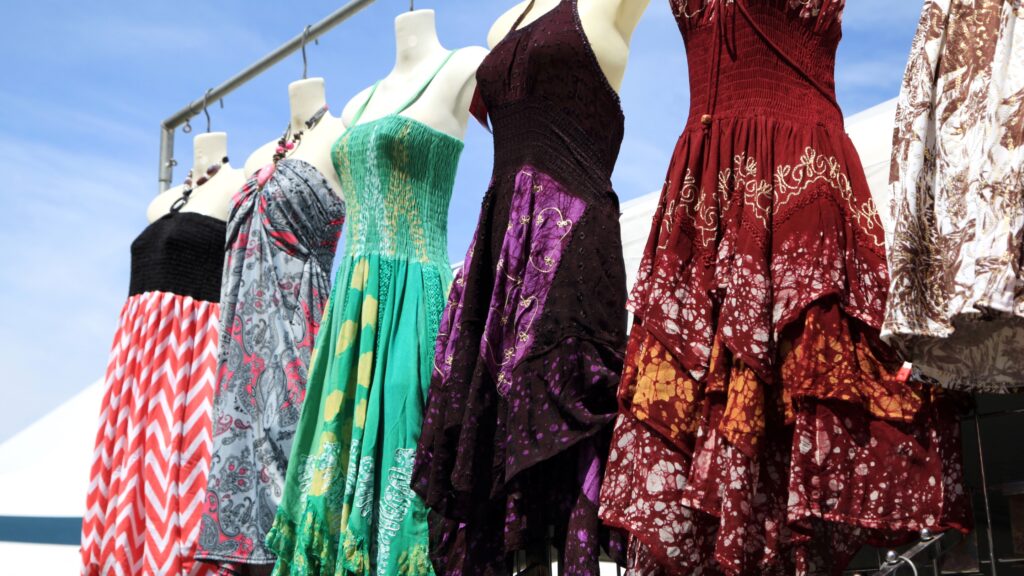 Colorful and trendy wedding guest dresses for summer on display.